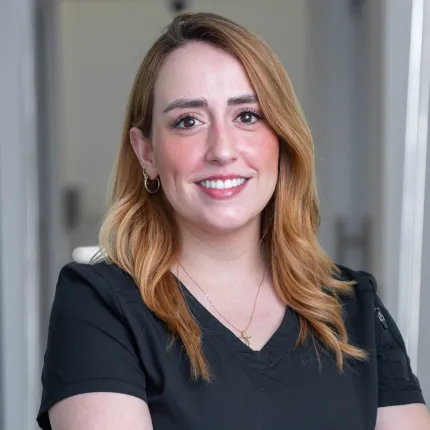 Dr. Michelle Villa at her desk in a dental clinic.